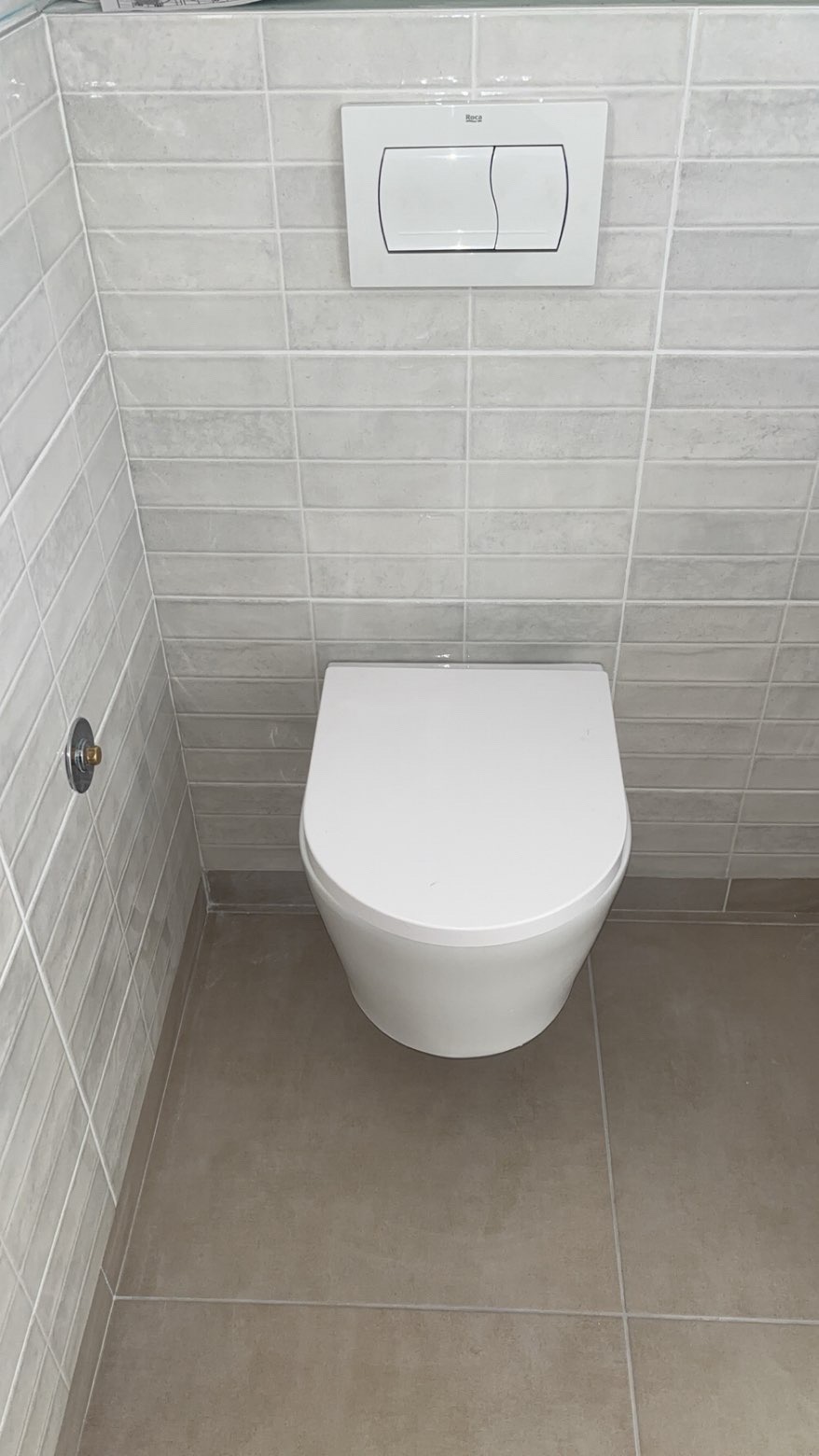 WC suspendu moderne avec carrelage gris - Plombier Île-de-France